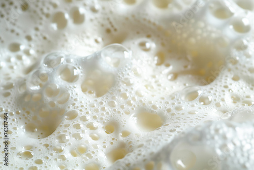 Close up of soapy foam texture as a background. Macro shot of bubbles with shimmering effect on the surface
