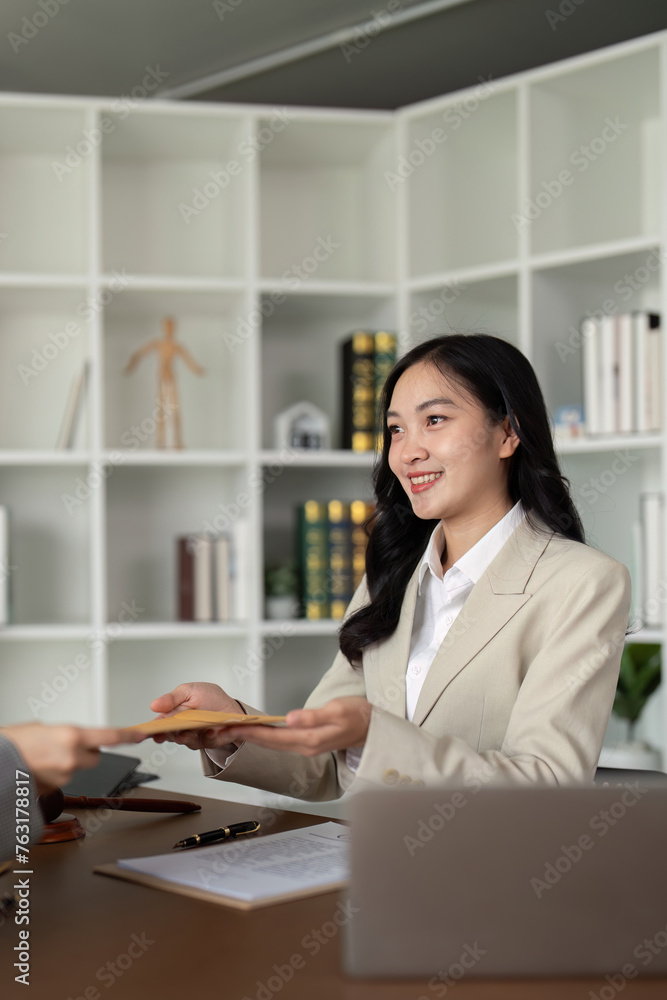 Lawyers woman and businesswoman discussing contract papers sitting at the table. Concepts of law, advice, legal service