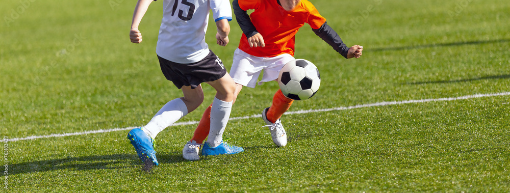 Boys Playing a Competitive Soccer Football Game. Young Players in Sports Duel. Kids Kicking the Ball During Junior Soccer League Boys Playing a Competitive Soccer Football Game. Young Players in Sports Duel. Kids Kicking the Ball During Junior Soccer League