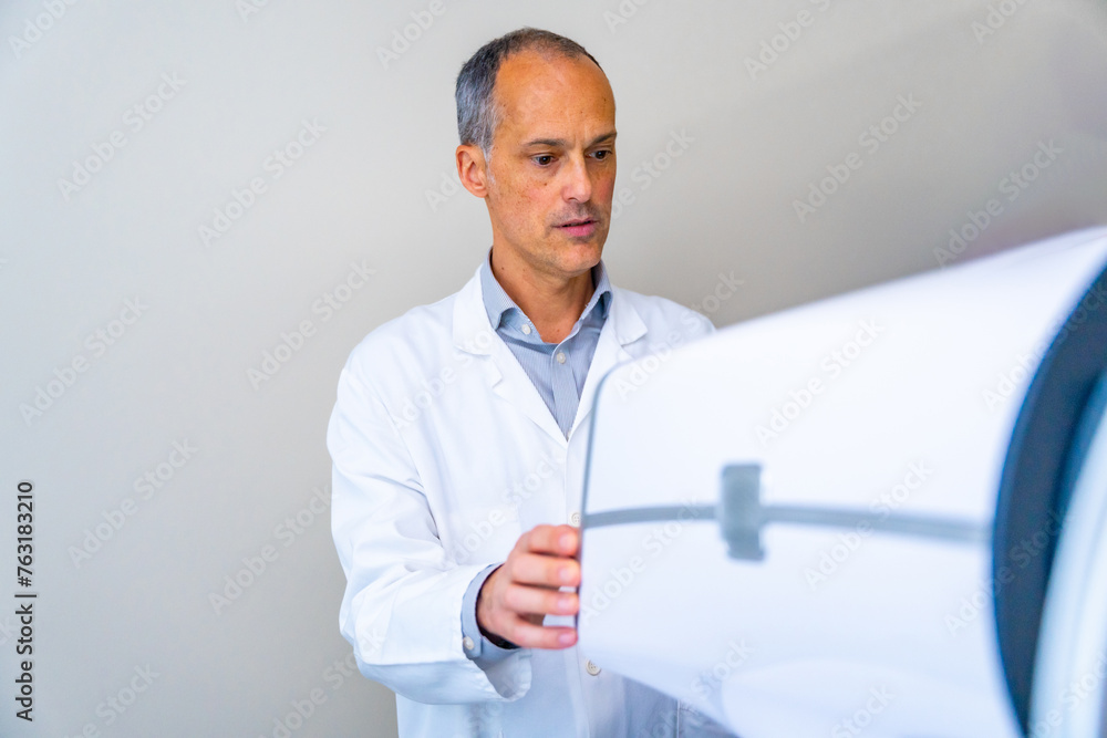 Ophthalmologist preparing an innovative laser machine for patients with glaucoma Ophthalmologist preparing an innovative laser machine for patients with glaucoma