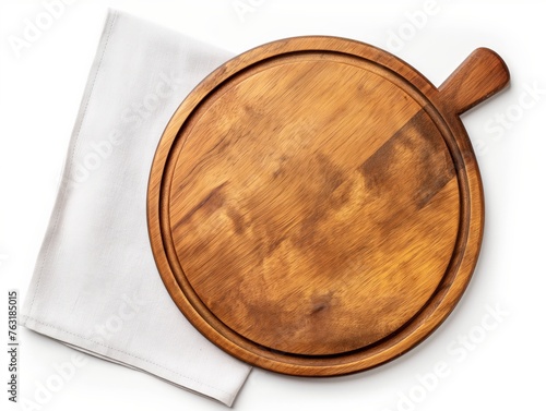 Empty round wooden pizza board with handle on a white linen cloth, top view.