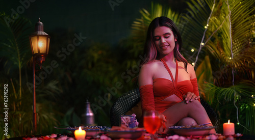 Indian Asian Hindu cute woman lady sitting chair outdoor house garden happy young female enjoy self love late night dinner party fun joy weekend break home park	