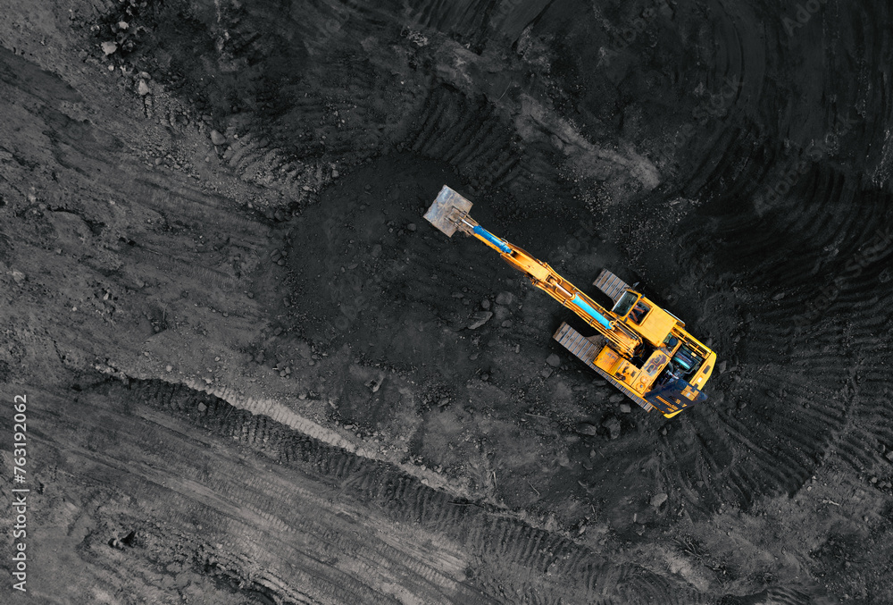 Coal mining in an open pit. Mining excavator loads coal in haul truck in quarry. Excavator digging in an open pit coal mine. Tipper truck hauling minerals from open-pit. Heavy machinery in opencast. Coal mining in an open pit. Mining excavator loads coal in haul truck in quarry. Excavator digging in an open pit coal mine. Tipper truck hauling minerals from open-pit. Heavy machinery in opencast.