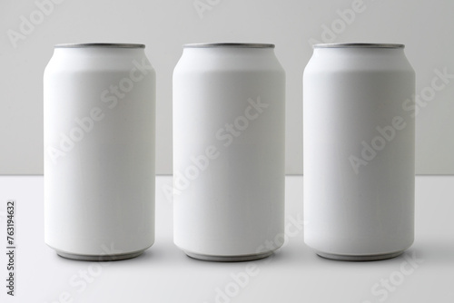Three matte aluminium drink cans mockup. (real photo) Beer, soda, pop, soft drink. Product shot.  (ID: 763194632)