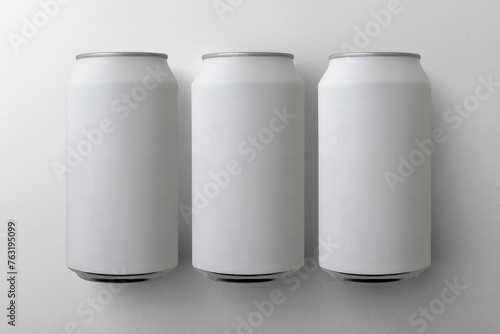 Three matte aluminium drink can mockups. (real photo) Beer, soda, pop, soft drink. (ID: 763195099)