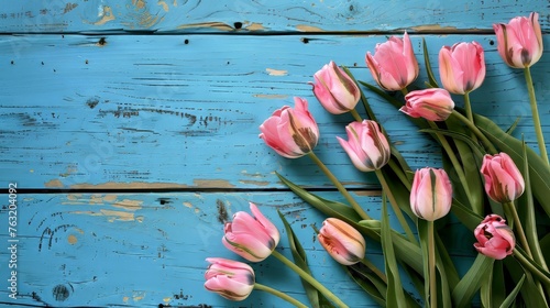 A group of pink tulips beautifully arranged on a vibrant blue background.