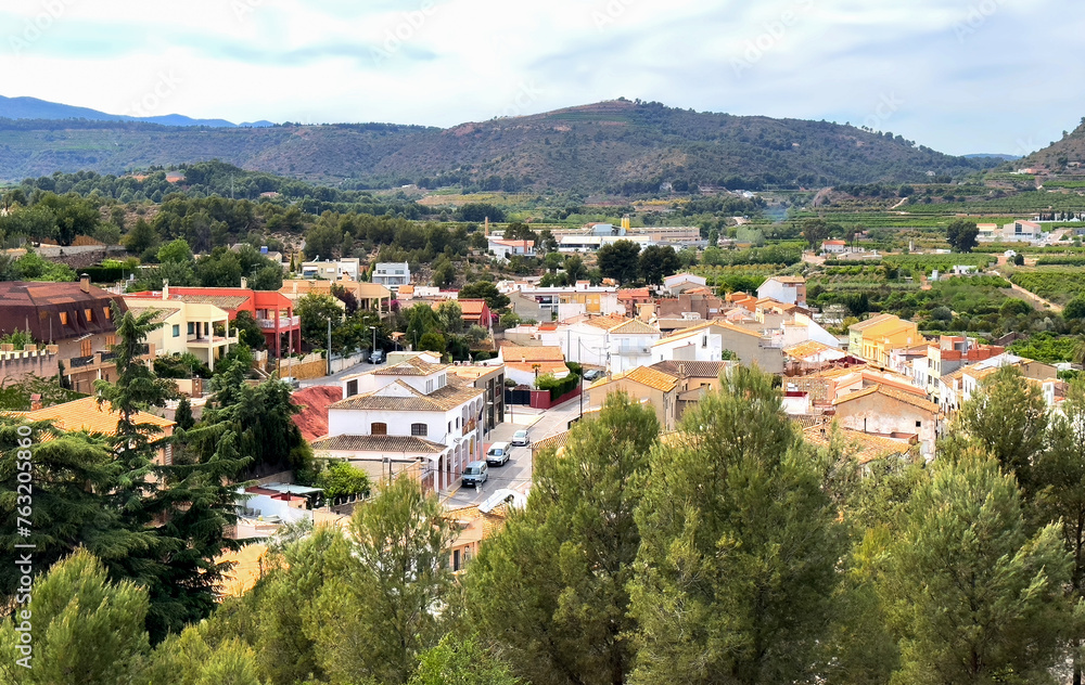 Torres Torres town village, Valencia, Spain. Rural landscape. Buildings and houses in city. Town at mountain. Town at Mountains hills. Houses roofs in countryside. Olive farm field, Orange field