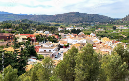 Torres Torres town village, Valencia, Spain. Rural landscape. Buildings and houses in city. Town at mountain. Town at Mountains hills. Houses roofs in countryside. Olive farm field, Orange field