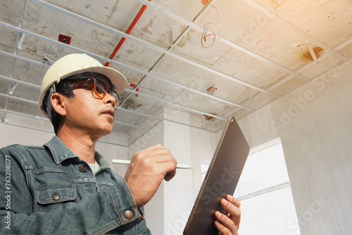 Canvas Print A home inspector or engineer examines the building structure and ceiling home construction specifications