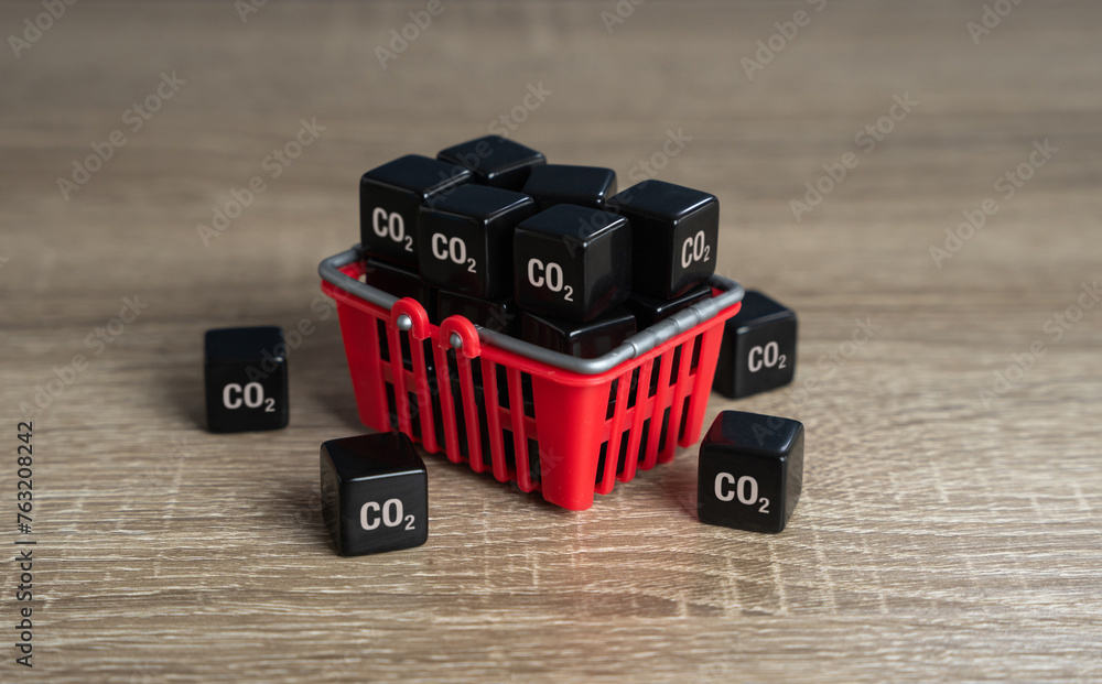 Shopping basket and cubic CO2 carbon dioxide. Achieve an understanding of impact on the environment by your lifestyle and habits. Greenhouse gas consumption and footprint. Customers carbon footprint. - obrazy, fototapety, plakaty 