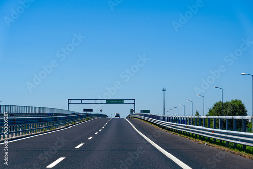 Driving on Italian highway near village of Villesse on a sunny summer day. Photo taken August 11th, 2023, Villesse, Italy.