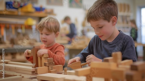 Children's woodworking class. Two young boys deeply focused on assembling wooden blocks and shapes at a woodworking table, in a classroom setting with shelves and other children in the background.