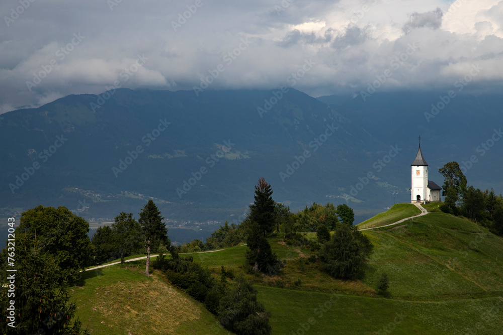Jamnik, Slovenia - Magical cloudy summer day at Jamnik St.Primoz church. Jamnik, Slovenia - Magical cloudy summer day at Jamnik St.Primoz church.