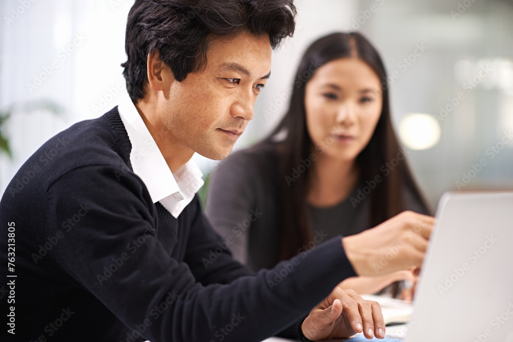 Business people, laptop and working in a office with Japanese staff and corporate team. Management, tech and internet research for company project at a startup with consulting firm with planning Business people, laptop and working in a office with Japanese staff and corporate team. Management, tech and internet research for company project at a startup with consulting firm with planning