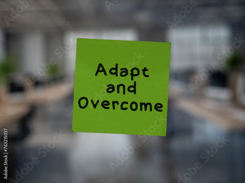 Post note on glass with 'Adapt and Overcome'.