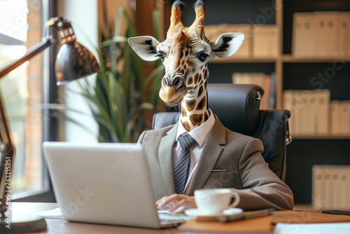 A giraffe wearing glasses sits at a desk in front of a computer. The giraffe is dressed in a suit and tie, giving the impression that it is a businessman, wearing a suit and working in an office photo