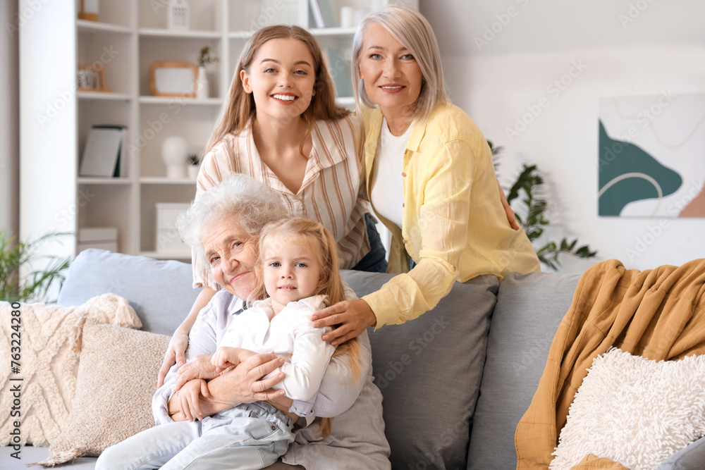 Little girl with her family sitting on sofa at home Little girl with her family sitting on sofa at home
