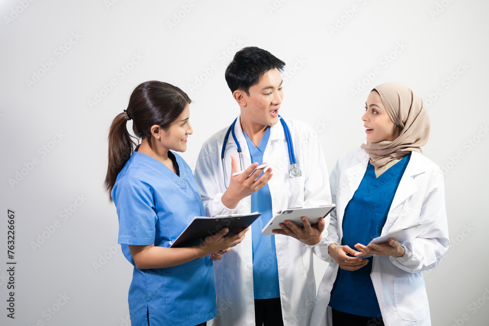 Successful team of medical doctors looking at camera and smiling while standin. Health, professional and people team in white background Successful team of medical doctors looking at camera and smiling while standin. Health, professional and people team in white background