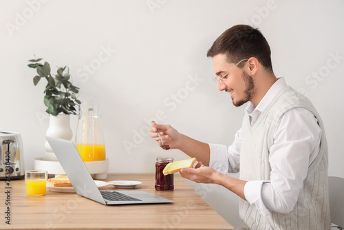 Young man with laptop havin...