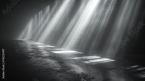 Abstract light beams through slits in dark room