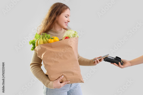 Young woman with paper bag ...