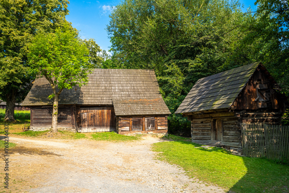 Old wooden wallachia houses in old village with green meadow. Roznov pod Radhostem. Czech Republic. Old wooden wallachia houses in old village with green meadow. Roznov pod Radhostem. Czech Republic.