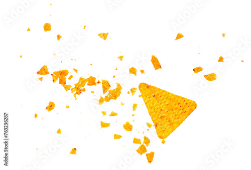 Pile tortilla chips crumbs, yellow pieces flying isolated on white background