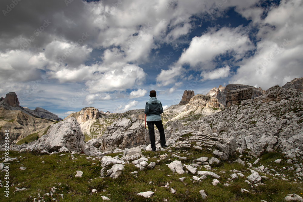 Stunning view of a tourist enjoying the view in the Tre Cime Di Lavaredo National park, Dolomites, Italy.
