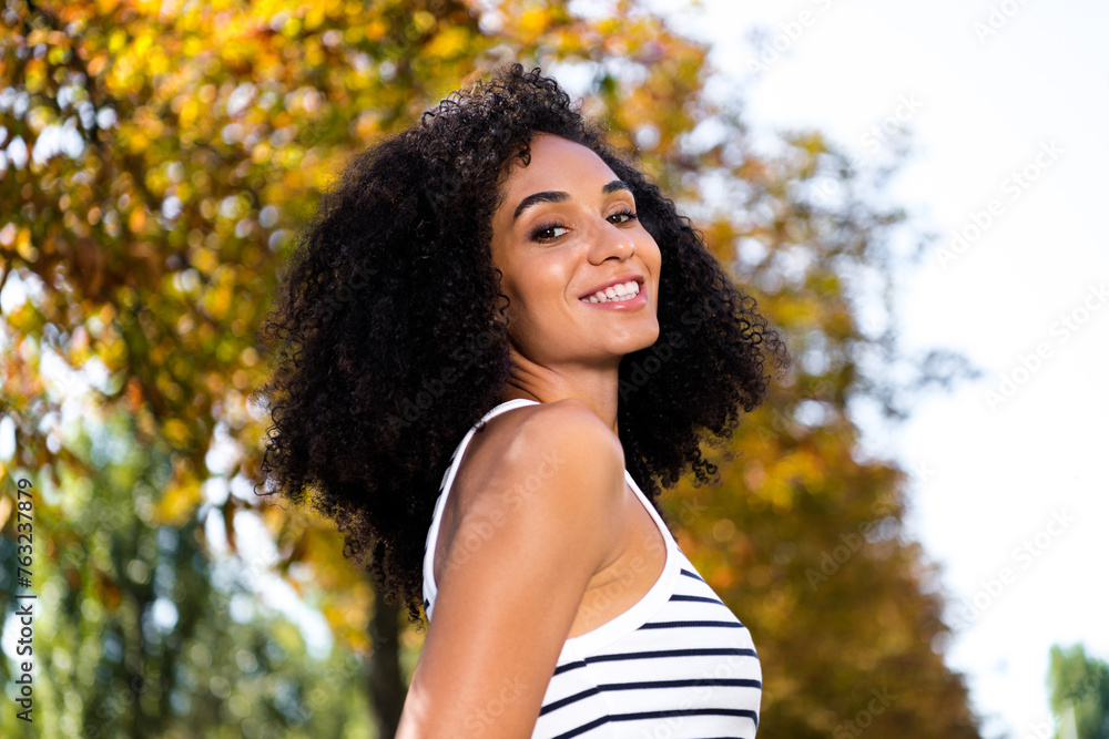 Photo of positive optimistic shiny woman spending free time waking alone in park on sunny warm day Photo of positive optimistic shiny woman spending free time waking alone in park on sunny warm day