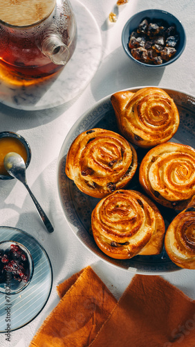 homemade pastries on a plate, light background, no people, close-up, cozy atmosphere, sunlight, top view