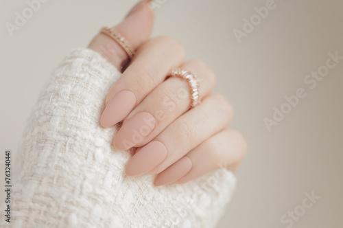 Beautiful classic beige manicure. Stylish nude manicure. Nail polish. Matte nails. Female hands manicure close up