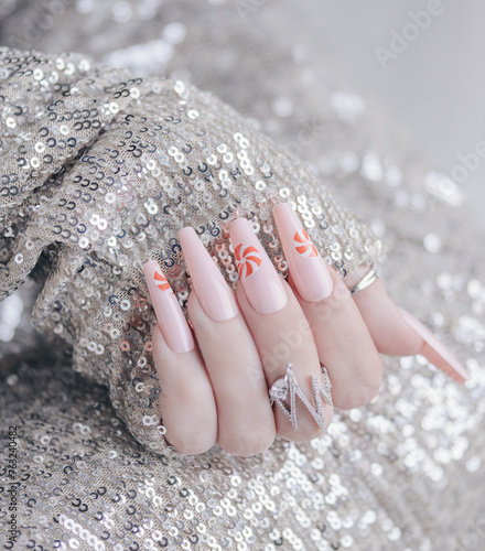 Beautiful pink manicure. Stylish pastel pink manicure with candy. Nail polish. Art nails. Candy nails. Female hands manicure close up