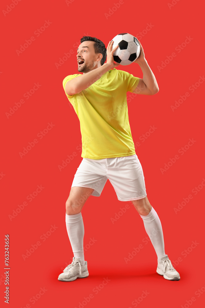 Portrait of male football player on red background Portrait of male football player on red background
