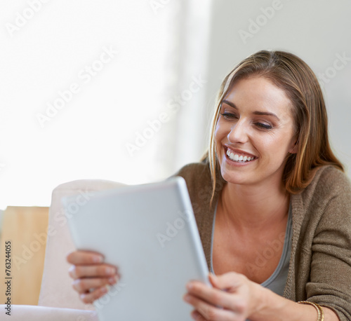 Woman, tablet and reading with smile in home for relax vacation entertainment, streaming or morning. Female person, living room and peaceful for ebook peace or web network, online or communication