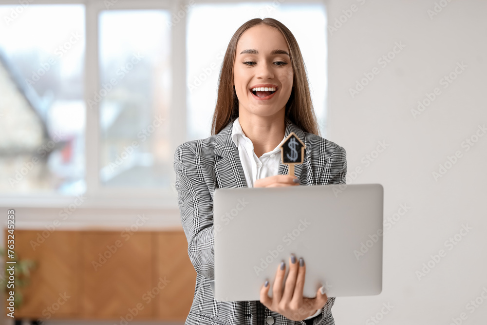 Portrait of female real estate agent with laptop in new apartment Portrait of female real estate agent with laptop in new apartment