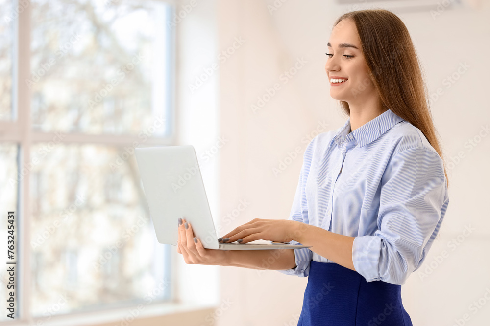 Portrait of female real estate agent with laptop in new apartment Portrait of female real estate agent with laptop in new apartment