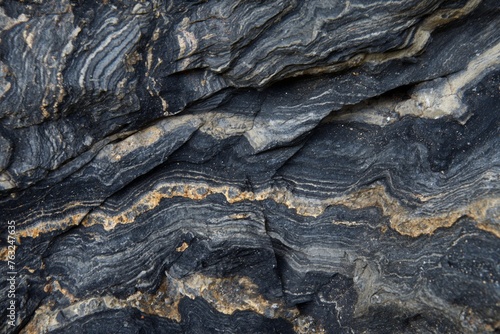 Close-up of layered black marble with natural gold patterns