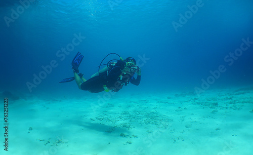 a woman diving in the crystal clear waters of the island of Curacao © gustavo
