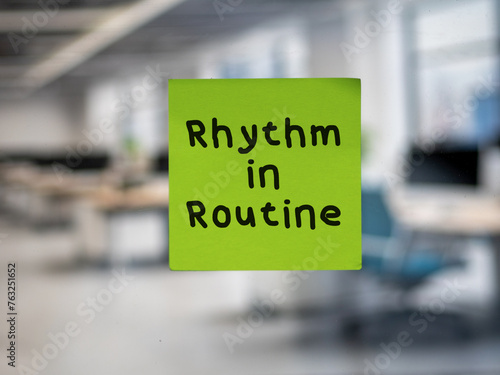 Post note on glass with 'Rhythm in Routine'.