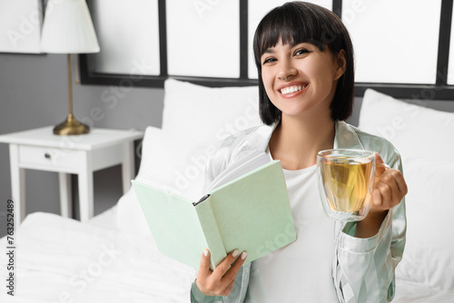 Young woman with cup of tea...