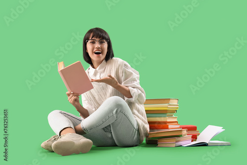 Young woman with books sitt...
