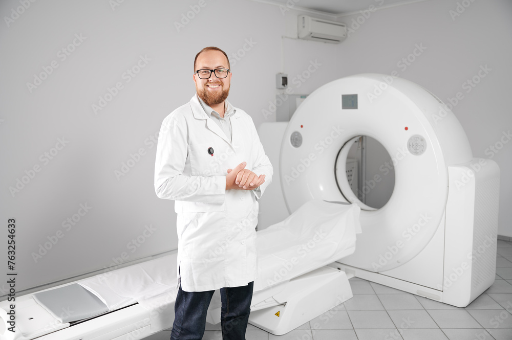 Portrait of smiling doctor with medical computed tomography or MRI scanner. Concept of medicine, healthcare and modern diagnostics. Portrait of smiling doctor with medical computed tomography or MRI scanner. Concept of medicine, healthcare and modern diagnostics.