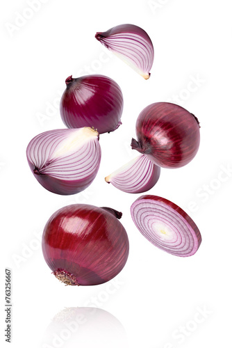 Red onion with slice flying in the air isolated on white background.