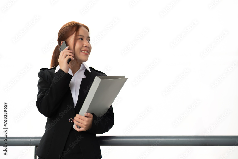 Portrait of young Asian businesswoman in suit talking on smartphone while standing in front of modern office building business concept and people Portrait of young Asian businesswoman in suit talking on smartphone while standing in front of modern office building business concept and people