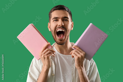 Happy young man with books ...