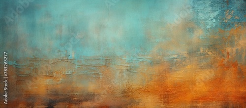 An abstract painting featuring tints and shades of electric blue and peach set against a brown wood frame. The blurred image shows a horizon, grass pattern, and hints of an event