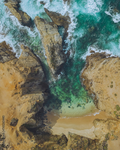 Aerial view of a beautiful beach cove with turquoise waters and rugged cliffs, Porto Covo, Sines, Portugal. photo