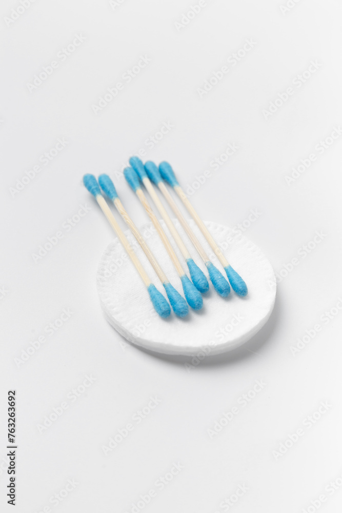 Cotton swabs buds and cotton pads on a white background. Cotton swabs buds and cotton pads on a white background.