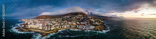 Panoramic aerial view of Bantry Bay and low cloud over Lion’s Head Mountain with Table Mountain in background at sunset, Bantry Bay, Cape Town, South Africa. photo