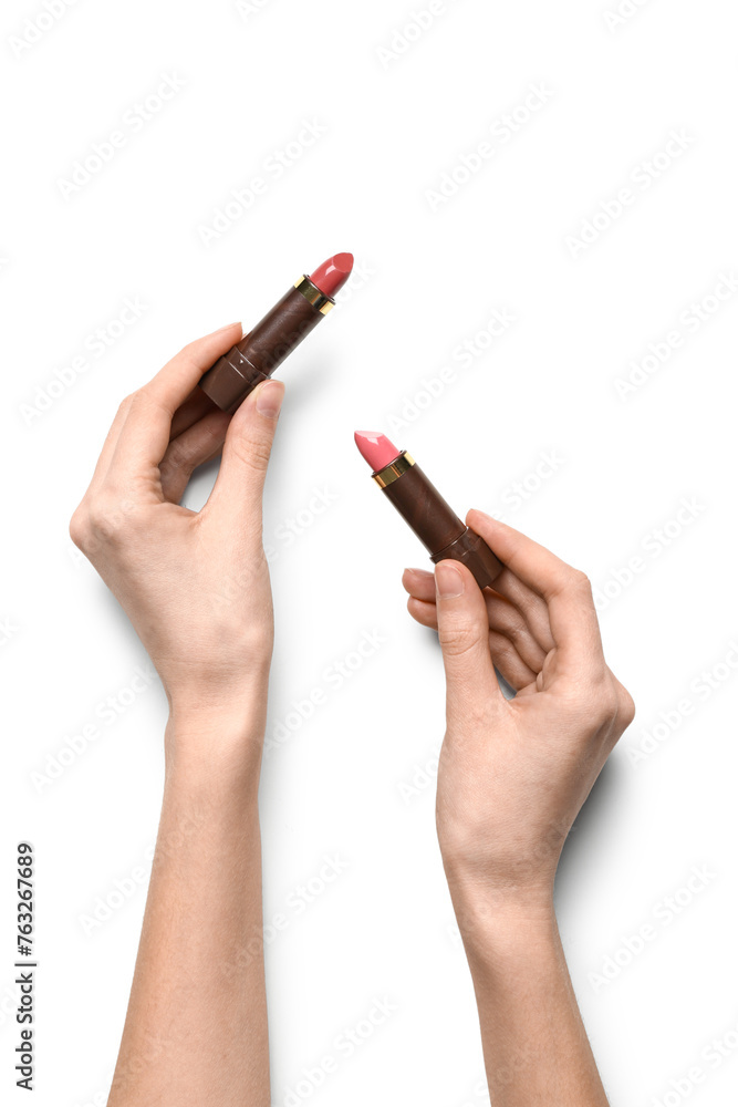 Female hands with color lipsticks on white background Female hands with color lipsticks on white background